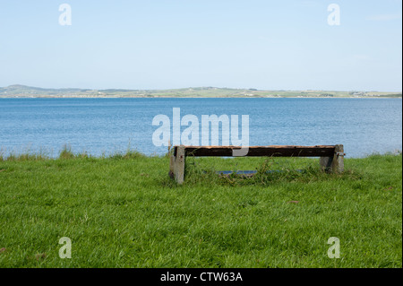 Eine leere Bank mit Blick auf eine schöne seelandschaft Landschaft. Stockfoto