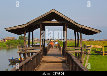 Birmanisch verwenden die angehobenen Gehweg in der Nähe des Dorfes MAING THAUK auf dem Weg zum Wochenmarkt - INLE-See, MYANMAR Stockfoto