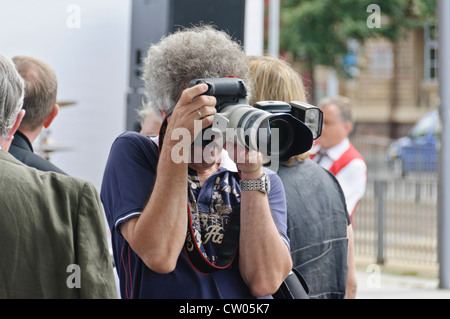 Reifen Sie Erwachsenen kaukasischen Mann mit grauen lockiges Haar, professionellen männlichen Fotografen fotografieren mit einem full-Frame DSLR Canon Stockfoto