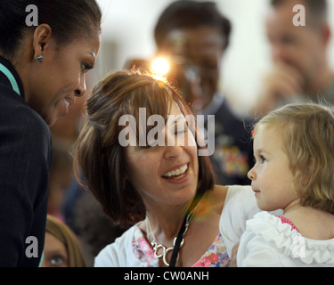 RAF MILDENHALL, England -- First Lady Michelle Obama begrüßt US-Militärfamilien bei RAF Mildenhall hier am 29. Juli 2012. Familien, die RAF Mildenhall, RAF Lakenheath und dem 501. Kampfunterstützungs-Flügel zugeordnet waren, gehörten zu den Familien, mit denen die erste Dame vor ihrer Abreise traf. Obama hielt an der Basis als Teil der Initiative der Vereinten Kräfte. Während ihres Aufenthalts in Großbritannien traf die First Lady im Rahmen von Let’s Move mit rund 1,000 britischen und amerikanischen Kindern zusammen. Kampagne und war auch die US-Präsidentendelegation für die Eröffnungsfeier der Olympischen Spiele 2012. Stockfoto