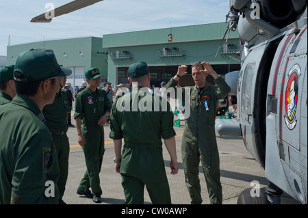 SAPPORO, Japan (29. Juli 2012) LT. Cmdr. Matt Meyers, ein Marineflieger, der Helicopter Anti-Submarine Squadron Light (HSL) 51 zugewiesen wurde, beschreibt die Fähigkeiten des SH-60B Seahawk Hubschraubers für Piloten und Flugpersonal der japanischen Maritime Self-Defense Force und der Japan Coast Guard auf der 26. Sapporo Air Show. HSL-51 wird derzeit in Japan zur Unterstützung der 7. US-Flotte eingesetzt. Stockfoto