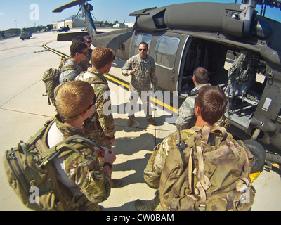 US Air Force Joint Terminal Attack Controller von der 227. Air Support Operations Squadron, 177. Fighter Wing, New Jersey Air National Guard, werden über die Sicherheitsverfahren von einem Soldaten aus dem 1-150. Angriff Hubschrauber Bataillon, New Jersey Army National Guard, August 2 am Atlantic City International Airport, New Jersey, New Jersey Das gemeinsame Training beinhaltete die Üben der Angriffe der JTAC von einem UH-60 Black Hawk Hubschrauber, gefolgt von einem 10 Meilen Ruck marsch. Stockfoto