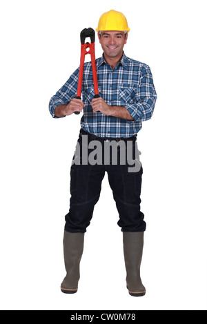 Handwerker mit einem riesigen Schraubenschlüssel Stockfoto