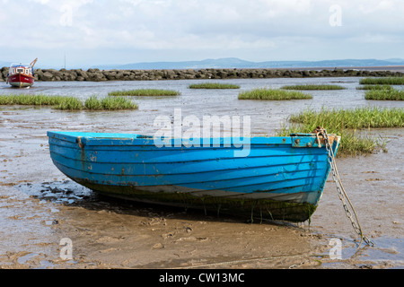 Alte blaue Ruderboot Strände durch die Ebbe in der Bucht von Morecambe, Lancashire Stockfoto