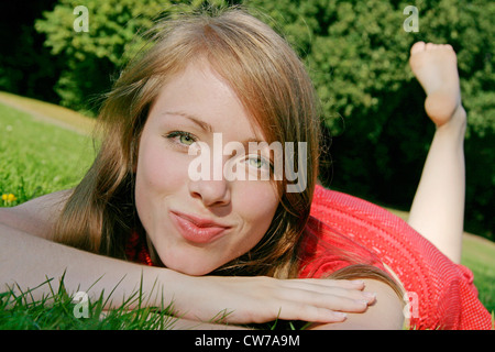 junge Frau liegend auf Wiese, Deutschland Stockfoto