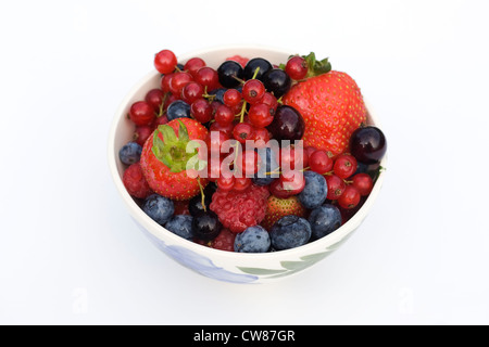 Bunte Sommerbeeren in eine Schüssel geben. Stockfoto