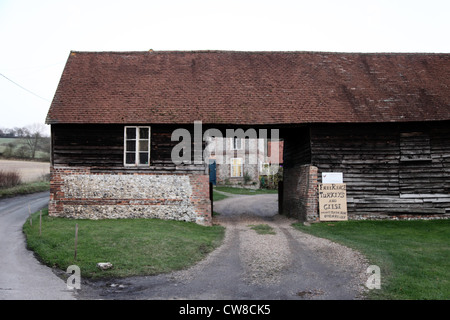 Es ist ein Foto von einem englischen Bauernhof auf dem Land in England. Wir sehen eine Scheune mit einen kleinen Tunnel, im Innenhof zu erreichen Stockfoto