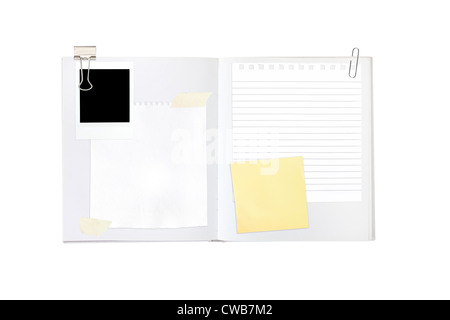 Scrapbook-Elemente inkl. Papiere und ein Foto auf ein leeres leeres Buch Stockfoto