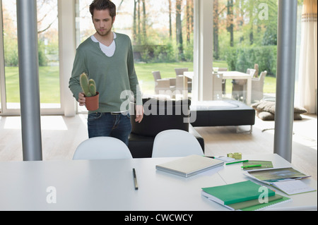 Mann hält einen Kaktus-plan Stockfoto