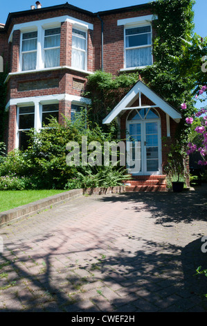 Ende des neunzehnten Jahrhunderts Doppelhaus in Süd-London mit einem Ziegelstein gepflastert Laufwerk oder Pull. Stockfoto