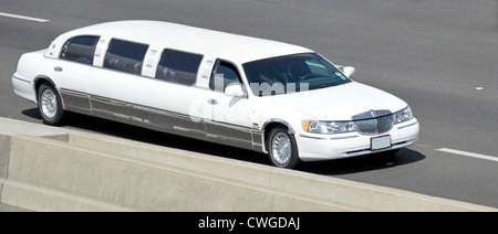 Weiße Stretch-Limousine mit Geschwindigkeit auf der Autobahn (verdeckt Nummernschild) Stockfoto