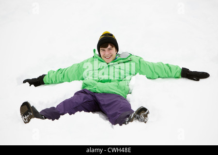 Teenager machen Schnee-Engel am Hang Stockfoto