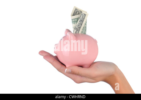 Nahaufnahme von einer Frau Hand hält ein rosa Sparschwein mit einer Dollarnote in den oberen Steckplatz stecken. Stockfoto