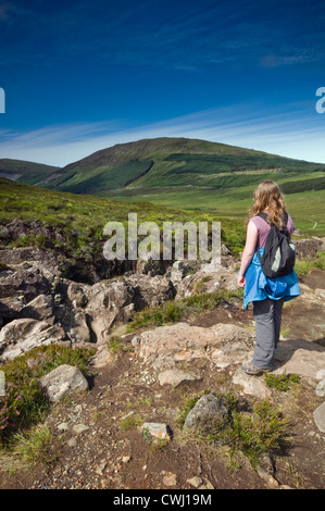 Eine junge weibliche Wanderer zu Fuß durch die Cuillin Berge in der Nähe von Glenbrittle auf der Isle Of Skye in Schottland, Großbritannien Stockfoto