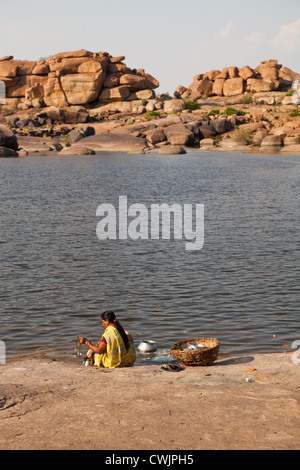 Indische Frau Wäsche waschen im Fluss Tungabhadra in Hampi Stockfoto