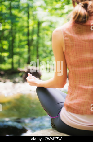 USA, New Jersey, Mendham, Frau üben Joga im Wald Stockfoto