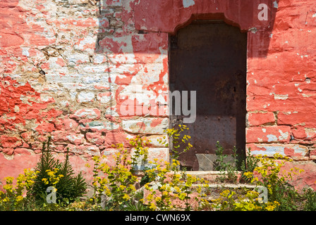 Bunte Fassade ein altes Steinhaus mit verwitterten Metalltür auf Pilion Halbinsel, Thessalien, Griechenland Stockfoto