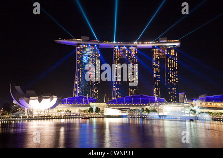 Lasershow von der atemberaubenden Marina Bay Sands strahlte Neuheit Wolkenkratzer in Singapur. ein Casino und Hotel bei Nacht auf eine Show beleuchtet Stockfoto