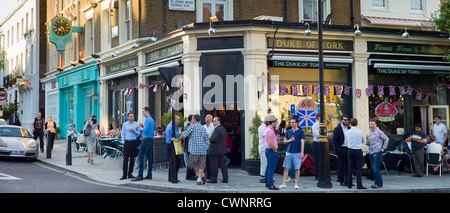 Menschenmenge im Freien, die sich bei warmem Wetter im Londoner Pub Duke of York in St John's Wood, Großbritannien, treffen und draußen trinken Stockfoto