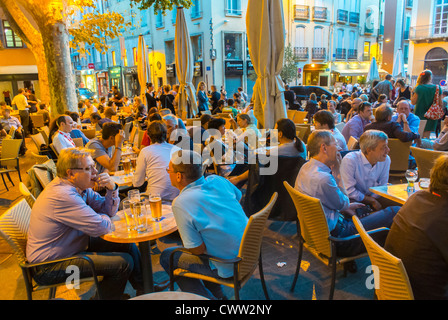 Perpignan, Frankreich, Menschenmenge, gemeinsames Trinken im französischen Bistro, Café, Restaurantterrasse in der Abenddämmerung, Feiertage im Freien überfülltes Restaurant Stockfoto