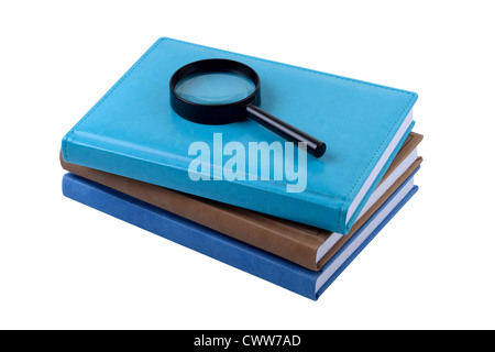 Drei Bücher und Lupe Stockfoto