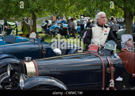 Mann stand neben seinem Vintage Bugatti Rennwagen in Prescott, Gloucestershire, England, UK. Stockfoto