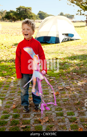 Ein 5 Jahre alter Junge hält einen Drachen. Stockfoto