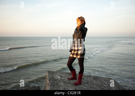 Blonde Mädchen den Sonnenuntergang am Meer Stockfoto