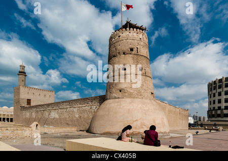 Zwei Frauen sitzen außerhalb der Al Fahidi Fort (1787), in dem sich das Dubai Museum am 3. Dezember 2004 in Dubai, VAE Stockfoto