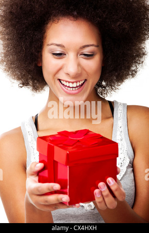 Schöne glückliche junge Frau hält einen roten Weihnachtsgeschenk, isoliert auf weiss Stockfoto