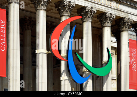 Paralympisches Rot, Blau und Grün drei Agios in Symbol, die auf den Säulen der Kolonnade der National Gallery im Trafalgar Square London, England, angebracht sind Stockfoto