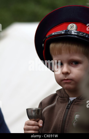 Junge in uniform Mütze von Don Kosaken aus metallischen Becher trinken Stockfoto