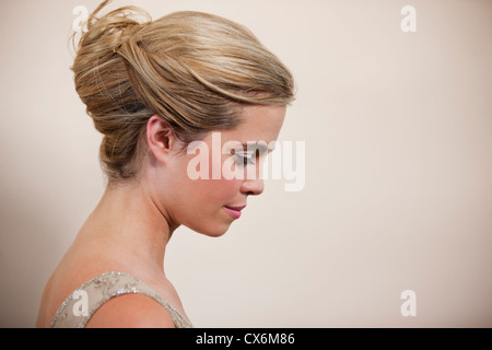 Eine junge Frau mit ihrem Haar, Blick nach unten Stockfoto