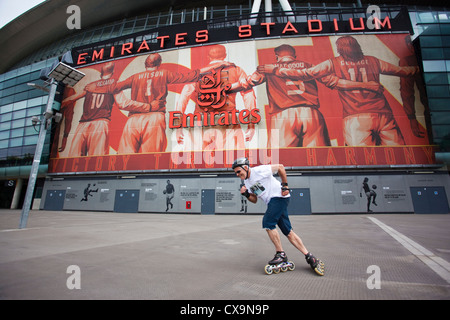 Mann-Inline-Skating außerhalb der Emirates-Stadion, Heimat des Fußballvereins FC Arsenal, Finsbury Park, Nord-London, England, UK Stockfoto