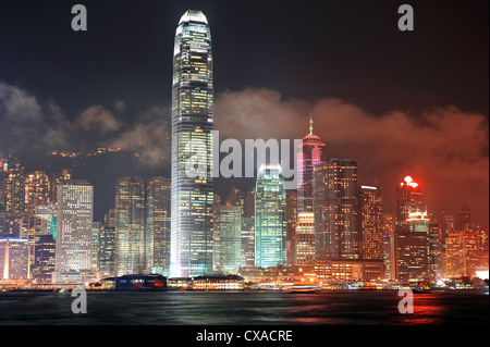 Hong Kong Skyline bei Nacht mit Wolken über den Victoria Harbour. Stockfoto