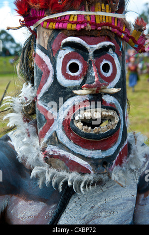 Bunt gekleidet und Gesicht gemalt lokalen Stämme feiert die traditionelle Sing Sing im Hochland von Papua-Neuguinea Stockfoto