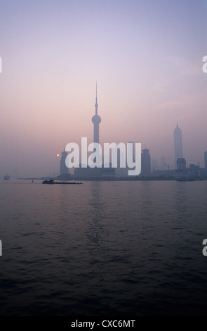 China, Shanghai, Blick über den Huangpu-Fluss in Richtung der Oriental Pearl tower bei Sonnenaufgang. Stockfoto