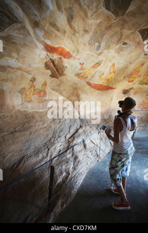 Touristen, die die Fotos von alten Fresken, Sigiriya, UNESCO-Weltkulturerbe, North Central Province, Sri Lanka, Asien Stockfoto