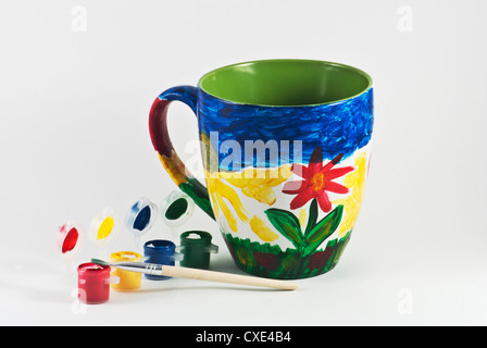 Bunte Tasse mit Wasserfarben und Pinsel Stockfoto