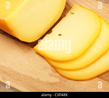 Käsescheiben auf Schneidebrett Stockfoto