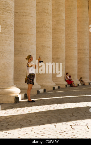 Frau, die ein Bild an der Fassade der Basilika von St. Peter, Vatikan, Rom, Roma, Italy, Italia, Europa Stockfoto