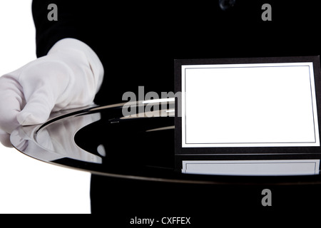 Weiß behandschuhten Hand hält ein silbernes Tablett mit einer leeren Karte Stockfoto