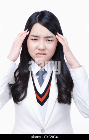 Schulmädchen mit Kopfschmerzen Stockfoto