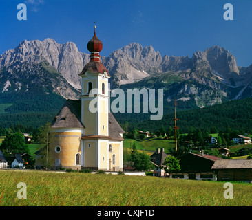 Kirche im Dorf Going mit dem Wilden Kaiser Gebirge über. Tirol, Österreich. Stockfoto