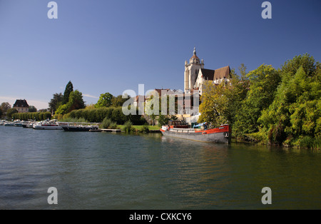 Französische Kirche am Riverside in Dole, mit Booten und Pontons an einem hellen Sommertag. Stockfoto