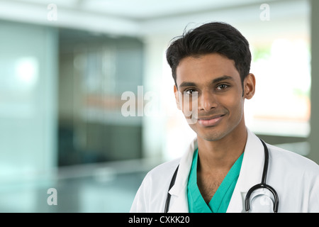 Junge männliche indische Arzt trägt einen weißen Kittel und Stethoskop. Stockfoto