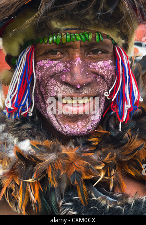 Porträt eines Mannes mit seinem Gesicht gemalt und tragen Vogelfedern an Singsing Goroka Festival, Papua New Guinea Stockfoto