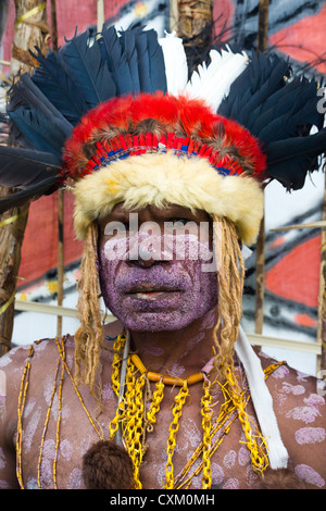 Porträt eines Mannes mit seinem Gesicht bemalt und tragen eine Kopfbedeckung bei Singsing Goroka Festival, Papua New Guinea Stockfoto