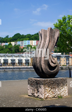 Skulptur neben Floating Harbour, Bristol mit den bunten Häusern von Hotwells in der Ferne. Stockfoto