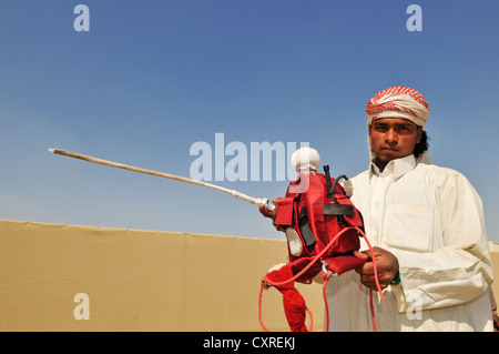 Jockey hält einen Roboter Jockey, Al Sheehaniya, Kamelrennen Track, Doha, Katar, Vereinigte Arabische Emirate, Naher Osten Stockfoto